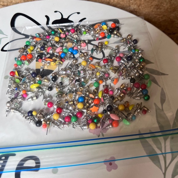 Bag full of different colored stud earrings. - Picture 2 of 13